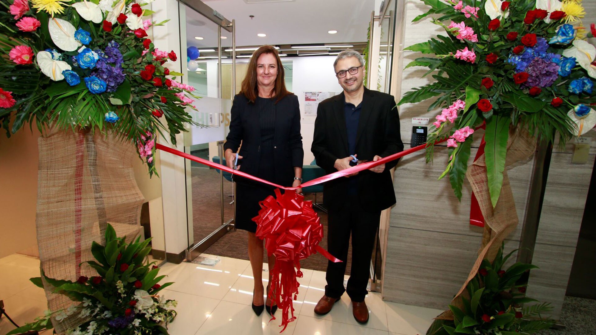 Download image (.jpg) Caroline Clarke and Ashwin Chari during the ribbon cutting ceremony for the new Philips Philippines opening  (opens in a new window)